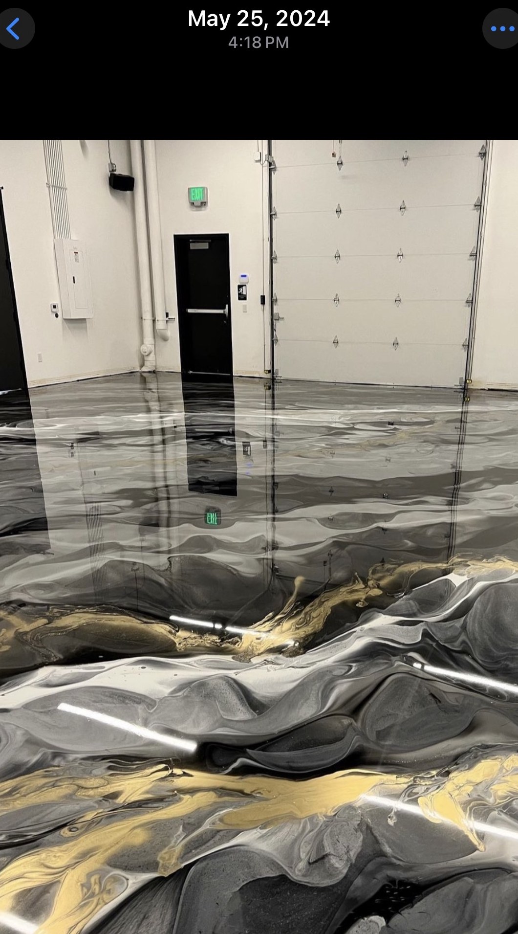 Gold, white, and charcoal metallic epoxy floor in a commercial space