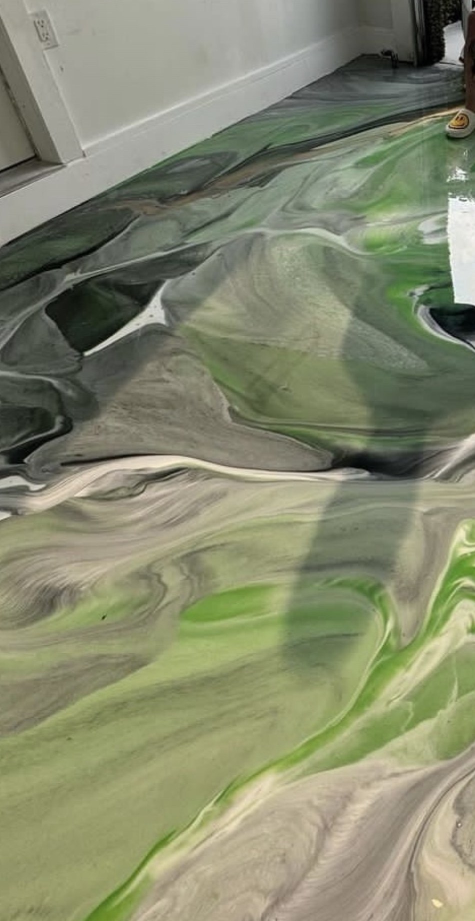 Close detail of a green and grey metallic epoxy floor pattern