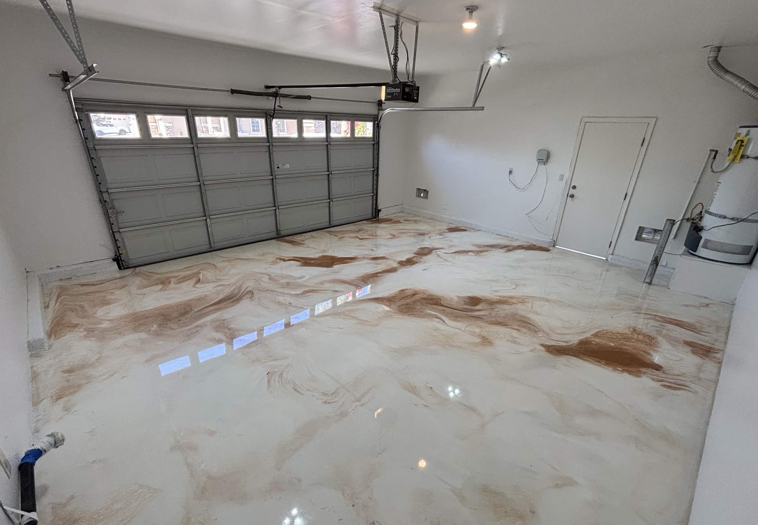 Real residential garage with a glossy copper and white metallic epoxy floor